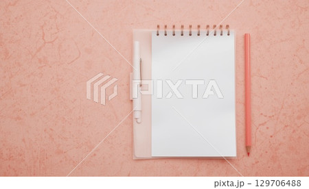 Top View of Notebook with Pencil and Pen on Pink Desk. 129706488