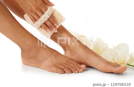 Scrub, pedicure and woman feet in studio for spa, luxury and skincare with floral product advertising. Skin care, beauty and natural flowers for cosmetics foot isolated on white background marketing Scrub, pedicure and woman feet in studio for spa, luxury and skincare with floral product advertising. Skin care, beauty and natural flowers for cosmetics foot isolated on white background marketing 129706520