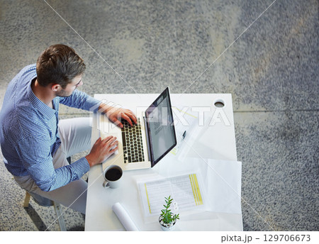 Top view, business and man with laptop, typing and planning for schedule, project deadline and office. Male employee, ceo and entrepreneur with digital marketing, online research and web launch Top view, business and man with laptop, typing and planning for schedule, project deadline and office. Male employee, ceo and entrepreneur with digital marketing, online research and web launch 129706673