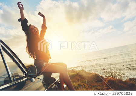 Road trip, freedom and woman sunset on beach for travel, journey and summer holiday celebration. Celebrate, girl portrait on vintage, retro car for outdoor vacation, parking and nature drive by ocean 129706828