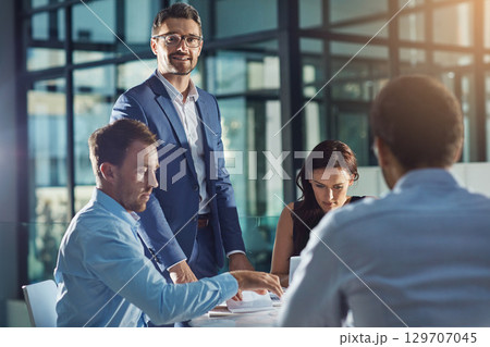 Business people, office and meeting for strategy, planning and success with teamwork, vision and leader. Businessman, leadership and group at desk with woman, black man and documents for innovation 129707045
