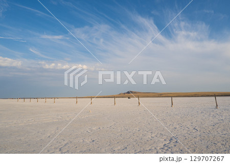 Landscape of the salt lake Baskunchak. View of Mount Big Bogdo. Astrakhan region, Russia Landscape of the salt lake Baskunchak. View of Mount Big Bogdo. Astrakhan region, Russia 129707267