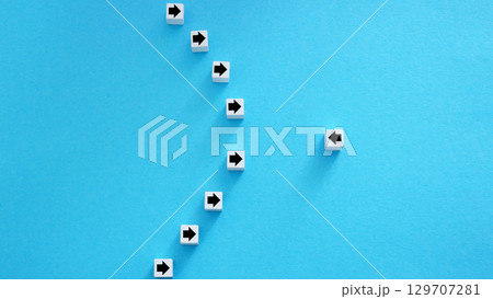 Resistance or individuality. Line of arrows in one direction and one in opposite. 129707281