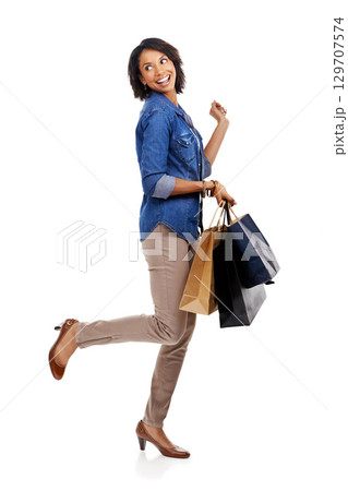 Fashion, shopping or excited black woman in studio on white background with marketing mockup space. Celebration, sales or happy girl customer with shopping bags on discount deals or promotional offer Fashion, shopping or excited black woman in studio on white background with marketing mockup space. Celebration, sales or happy girl customer with shopping bags on discount deals or promotional offer 129707574