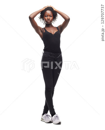 Fashion, beauty and portrait of a black woman in a studio with a casual outfit, confidence and natural pose. Beauty, young and African female model with afro posing while isolated by white background 129707737