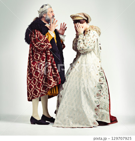 King man, queen and argue in studio with anger, frustrated and crying in relationship, theater and drama. Medieval royal couple, fight and conflict conversation in renaissance, stress and woman cry 129707925