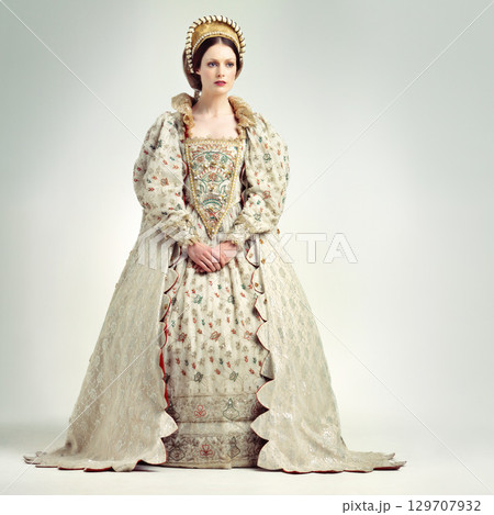 Fashion, royal and victorian queen in studio with a renaissance, luxury and fancy dress. Royalty, beauty and medieval woman ruler with elegant, vintage and regal costume isolated by white background. 129707932