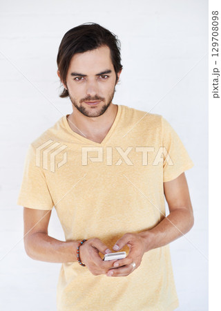 Young man, portrait with smartphone, social media and chat with communication, technology isolated on white background. Network, internet and phone for social network or gaming, tech and online Young man, portrait with smartphone, social media and chat with communication, technology isolated on white background. Network, internet and phone for social network or gaming, tech and online 129708098
