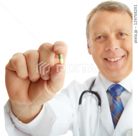 Portrait, doctor and man with pills in studio isolated on a white background. Face, healthcare and happy medical worker, pharmacist and mature male holding drug medicine, medication or capsule remedy 129708201