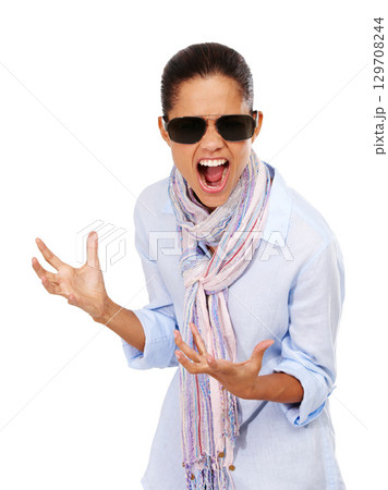 Angry, frustrated and anxiety of a woman with sunglasses in in studio to scream for stress and depression. Mental health of female isolated white background for anger, psychology and crazy portrait Angry, frustrated and anxiety of a woman with sunglasses in in studio to scream for stress and depression. Mental health of female isolated white background for anger, psychology and crazy portrait 129708244