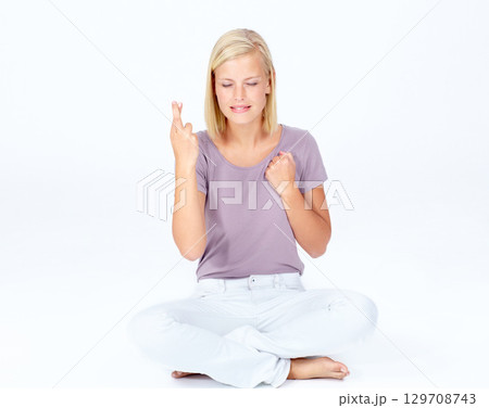 Woman, hands or fingers crossed on mockup studio background, marketing space or advertising mock up. Nervous, beautiful model or hand gesture in hope, good luck wish and sitting on isolated backdrop Woman, hands or fingers crossed on mockup studio background, marketing space or advertising mock up. Nervous, beautiful model or hand gesture in hope, good luck wish and sitting on isolated backdrop 129708743