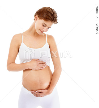 Pregnancy, love and woman holding her stomach in a studio for prenatal care, motherhood and happiness. Maternity, health and happy pregnant female model embracing her tummy by a white background. Pregnancy, love and woman holding her stomach in a studio for prenatal care, motherhood and happiness. Maternity, health and happy pregnant female model embracing her tummy by a white background. 129708828