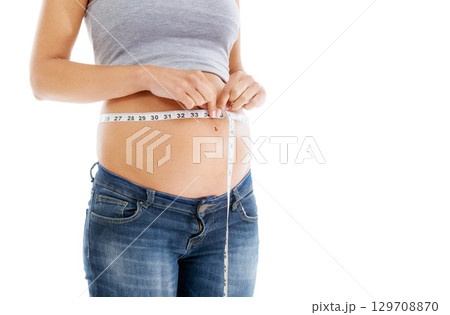Pregnant, measuring tape and stomach in studio as woman check growth, development and health on mockup. Abdomen, wellness and pregnant woman self care, diet and healthy progress on white background 129708870