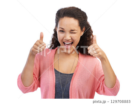 Face portrait, thumbs up and wink of woman in studio isolated on a white background. Hands gesture, like emoji or happy female model with sign for success, support or approval, thank you or agreement Face portrait, thumbs up and wink of woman in studio isolated on a white background. Hands gesture, like emoji or happy female model with sign for success, support or approval, thank you or agreement 129708883