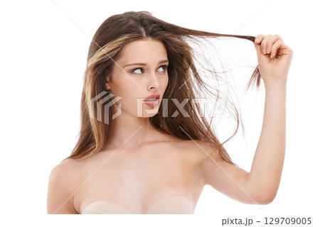 Beauty, hair care and woman with hair damage, loss and worry, isolated on white background. Salon, haircare and hair loss stress and concern on face, confused shocked girl with damaged hair in studio 129709005
