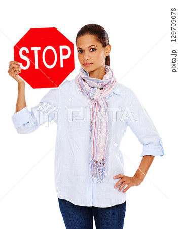 Woman with stop road sign, traffic rules and caution in portrait with stop sign isolated on white background. Warning sign, red with limit and danger, road regulations and young female with signage 129709078