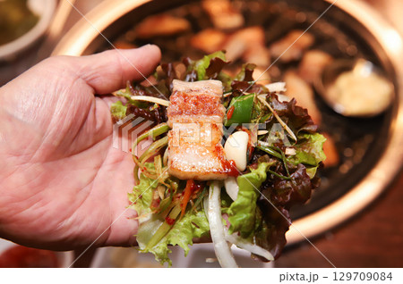 Korean bbq. ssam : eat pork wrapped in lettuce leaves Korean bbq. ssam : eat pork wrapped in lettuce leaves 129709084
