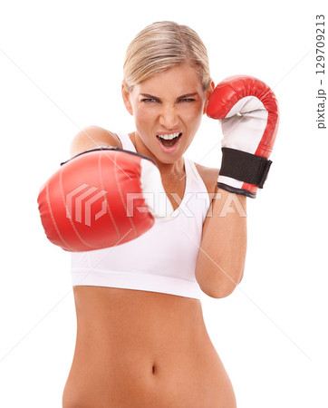 Sports, boxing gloves and portrait of woman punching with confidence and motivation to box, isolated on white background. Boxing, exercise and empowerment, female boxer ready for challenge in studio. 129709213