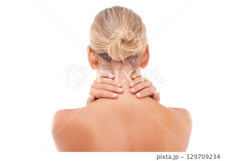 Neck pain, injury and woman in a studio with discomfort, stress or ache after a spa body care treatment. Self care, sore and back view of a female model with a muscle sprain by a white background. 129709234