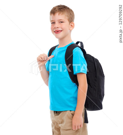 Backpack, happy and boy child in a studio with a casual, cool and natural outfit for back to school. Happiness, smile and portrait of a kid with a bag and stylish clothes isolated by white background 129709292