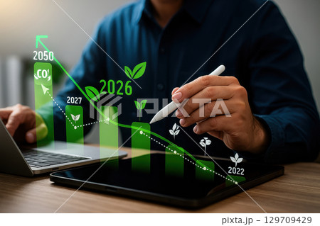 Man is using a tablet to draw a graph of the year 2030 129709429