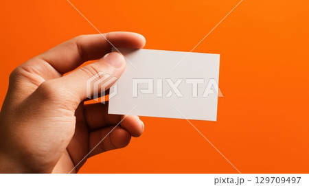 Hand holding a white business card 129709497
