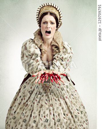 Queen woman, blood hands and studio with screaming, emergency and crime with ancient royal fashion. Medieval leader, crying and evil with shock, surprise and danger in renaissance clothes for murder 129709791