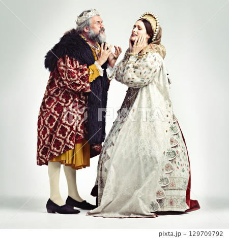 Royalty, renaissance and a king arguing with his queen in studio on a gray background for leadership of the monarchy. Couple, crown and history with a ruler and his wife fighting over the kingdom 129709792