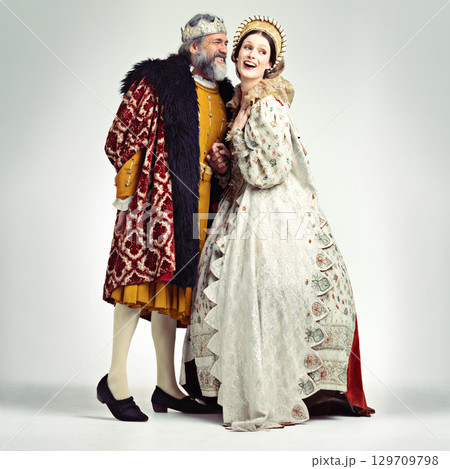 King, queen and love in medieval costume for royal party, retro carnival and theatre fashion clothes in white background. Couple, happy face and talking in vintage renaissance isolated in studio King, queen and love in medieval costume for royal party, retro carnival and theatre fashion clothes in white background. Couple, happy face and talking in vintage renaissance isolated in studio 129709798