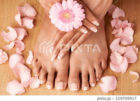 Relax, hands and feet of black woman with flower petals for luxury cosmetic treatment with manicure and pedicure nails. Healthy skincare of girl with daisy for beauty spa and wellness zoom. 129709917