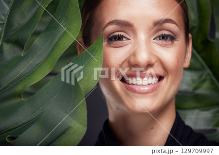 Beauty, skin and face with leaf and woman, skincare with nature aesthetic, natural cosmetics and facial portrait against studio background. Smile, glow with organic cosmetic treatment and wellness. 129709997