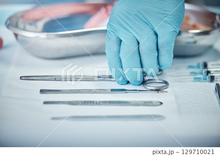 Surgery, tools and doctor hand with health, glove for safety and protection with medical equipment zoom. Surgeon, organize and cardiology healthcare, ready for cardiovascular surgical procedure. Surgery, tools and doctor hand with health, glove for safety and protection with medical equipment zoom. Surgeon, organize and cardiology healthcare, ready for cardiovascular surgical procedure. 129710021