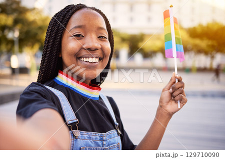 Black woman portrait, gay selfie and rainbow flag for lgbtq pride with a smile for sexuality freedom. Young lesbian girl in the city for equality and love for non binary and gender neutral lifestyle Black woman portrait, gay selfie and rainbow flag for lgbtq pride with a smile for sexuality freedom. Young lesbian girl in the city for equality and love for non binary and gender neutral lifestyle 129710090