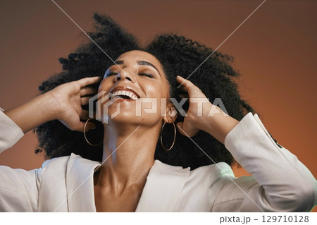 Hair care, beauty and black woman with makeup, hair and happy with afro and cosmetic care, face and skincare. Hairstyle with facial, natural curly hair texture and pride against studio background 129710128