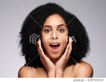 Face skincare, wow and surprised black woman in studio isolated on gray background. Makeup cosmetics, portrait and female model shocked after spa facial treatment for healthy skin, beauty or wellness Face skincare, wow and surprised black woman in studio isolated on gray background. Makeup cosmetics, portrait and female model shocked after spa facial treatment for healthy skin, beauty or wellness 129710143