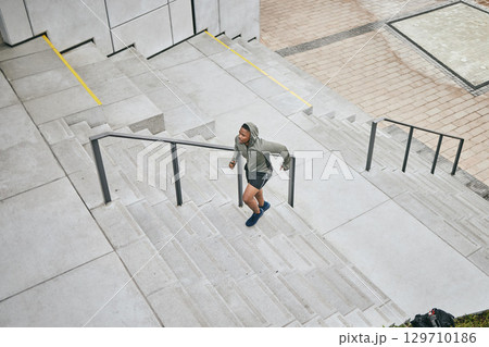 Running, stairs and city with a sports black man from above for a cardio or endurance workout for fitness. Training, exercise or motivation with a male runner or athlete moving up an urban staircase Running, stairs and city with a sports black man from above for a cardio or endurance workout for fitness. Training, exercise or motivation with a male runner or athlete moving up an urban staircase 129710186