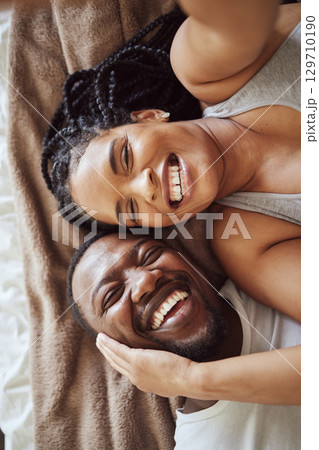 Selfie, love and black couple portrait in bedroom happy and funny while laughing on bed at home or hotel. Top view smile of a man and woman in marriage with commitment and happiness for social media Selfie, love and black couple portrait in bedroom happy and funny while laughing on bed at home or hotel. Top view smile of a man and woman in marriage with commitment and happiness for social media 129710190