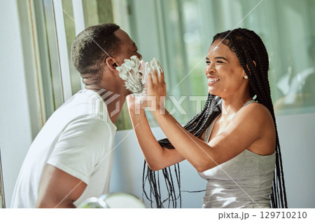 Shave, playing and funny with a black couple laughing or joking together in the bathroom of their home. Love, shaving and laughter with a man and woman having fun while bonding in the morning Shave, playing and funny with a black couple laughing or joking together in the bathroom of their home. Love, shaving and laughter with a man and woman having fun while bonding in the morning 129710210