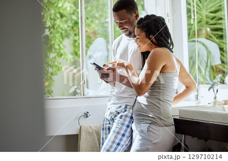 Phone, morning and black couple in bathroom in home on social media, networking or internet. Relax, pointing and happy man and woman on mobile smartphone for online shopping or streaming video. Phone, morning and black couple in bathroom in home on social media, networking or internet. Relax, pointing and happy man and woman on mobile smartphone for online shopping or streaming video. 129710214