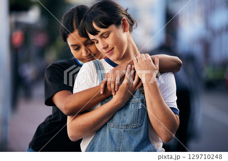 Support, hug and lgbt couple in the city with peace, freedom and love for identity in France. Pride, calm and lesbian women friends hugging for comfort and relax in lgbtq relationship in the street 129710248