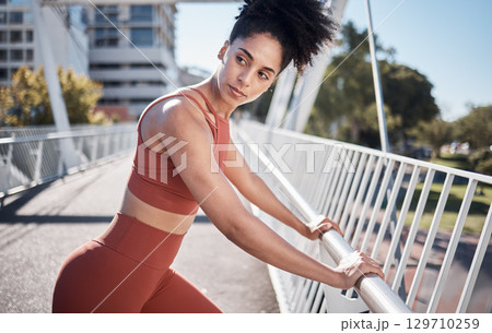 Black woman, fitness and stretching in the city for running exercise, workout or training preparation. Active African American woman in warm up stretch getting ready for run or healthy cardio in town 129710259
