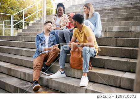 Relax, friends or students on steps at lunch break talking or speaking of goals, education or future. Diversity, school or happy young people in university or college bonding in social conversation 129710372