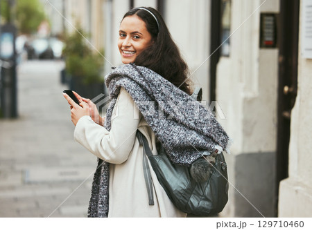 Walking, phone and portrait of woman travel on urban city street, road or on holiday adventure journey in London UK. Mobile smartphone, sidewalk and girl typing on winter vacation journey in England 129710460