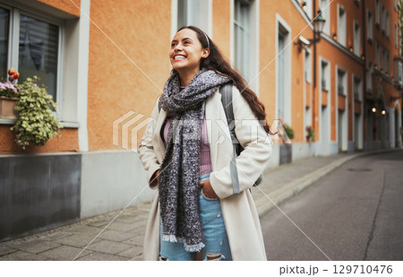 Excited, travel and walking woman in the city street for adventure, exploring and smile at architecture in France. Thinking, happy and girl on a walk in the road with an idea during a holiday Excited, travel and walking woman in the city street for adventure, exploring and smile at architecture in France. Thinking, happy and girl on a walk in the road with an idea during a holiday 129710476
