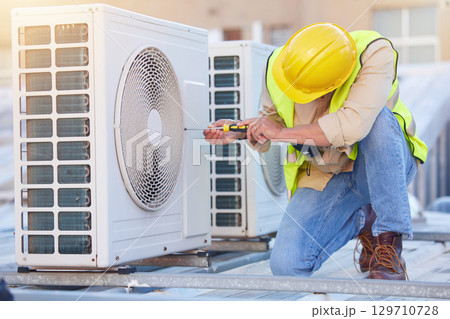 Air conditioning, technician or engineer on roof for maintenance, building or construction of fan hvac repair. Air conditioner, handyman or worker with tools working on a city development project job 129710728