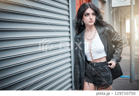 Young woman, fashion and streetwear with gen z punk style, outdoor and trendy, edgy and stylish in urban city. Youth, focus and beauty with rock aesthetic, fashion model in designer clothes in London 129710750