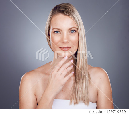 Woman, hair wellness and beauty portrait for salon growth, luxury cosmetics care and dermatology keratin treatment in grey studio background. Model face, skincare glow motivation and hair care shine 129710839
