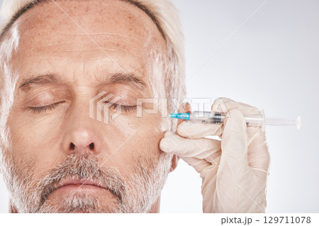 Man face, hands or cosmetic surgery needle on studio background for skincare collagen, medical dermatology or anti aging grooming. Zoom, plastic surgeon or mature patient injection for facial change 129711078