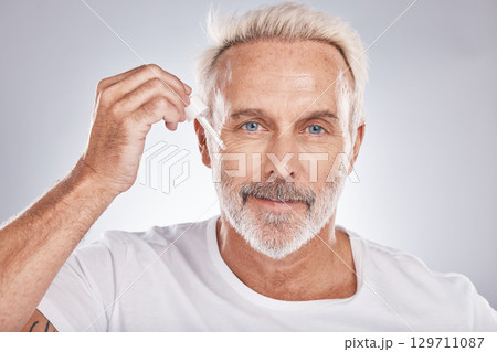 Senior man, facial portrait and oil skincare wellness, cosmetics beauty treatment and dermatology product in white studio background. Luxury spa, rich hyaluronic acid and face wrinkles serum dropper Senior man, facial portrait and oil skincare wellness, cosmetics beauty treatment and dermatology product in white studio background. Luxury spa, rich hyaluronic acid and face wrinkles serum dropper 129711087