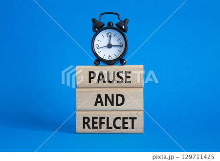 Pause and Reflect symbol. Concept words Pause and Reflect on wooden blocks. Beautiful blue background with alarm clock. Business and Pause and Reflect concept. Copy space. Pause and Reflect symbol. Concept words Pause and Reflect on wooden blocks. Beautiful blue background with alarm clock. Business and Pause and Reflect concept. Copy space. 129711425